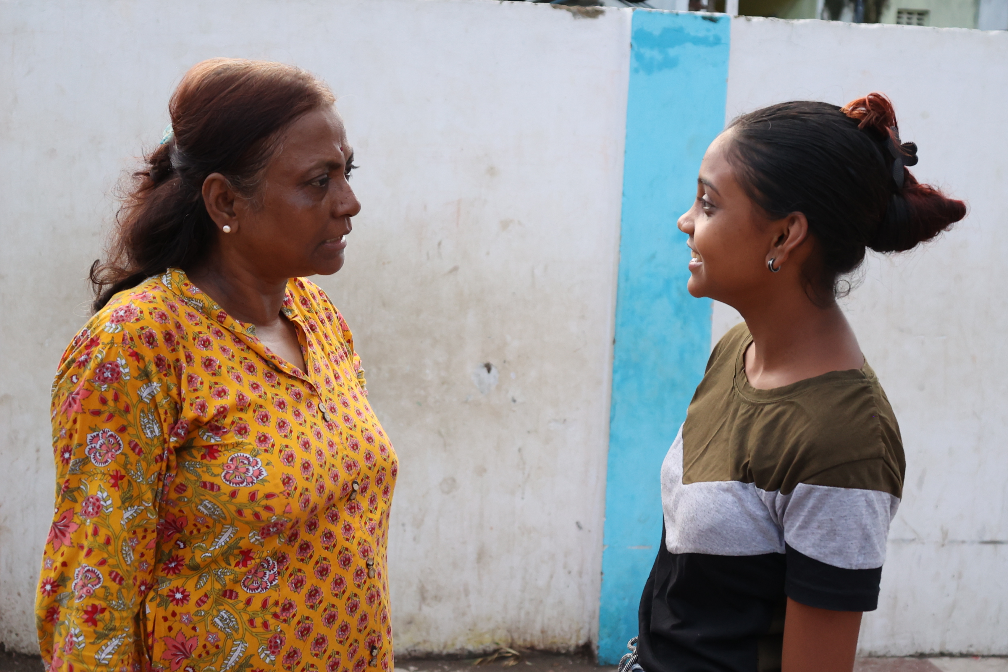 Hands holding soil with a plant