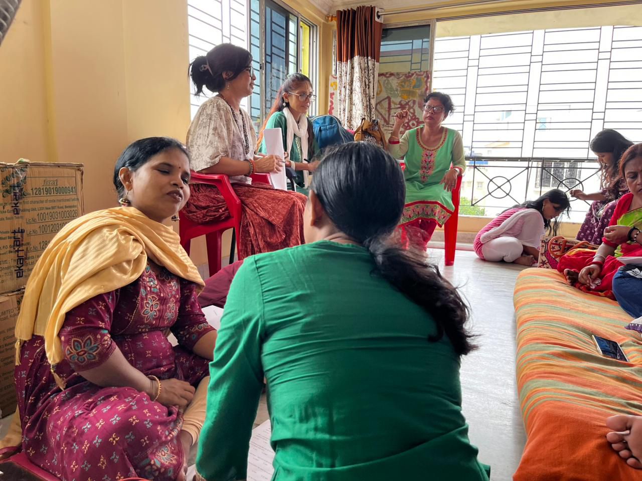 A small support session taking place inside a community room