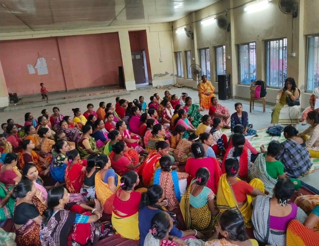 A group of women meeting and raising hands.